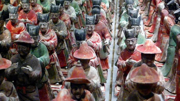 From among numerous rows of painted Terracotta figurines, one or two figurines appear to be peering curiously at the viewer. Taken at the Shaanxi History Museum in Xi'an, China.